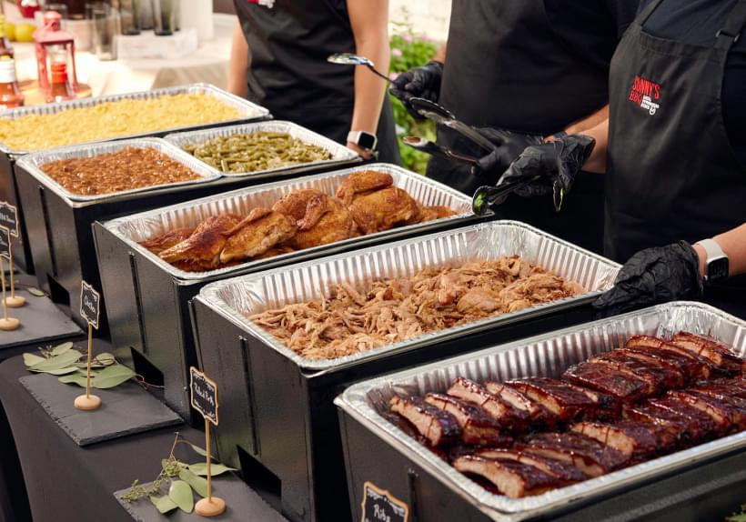 Sonny's Catering Team serves BBQ to guests