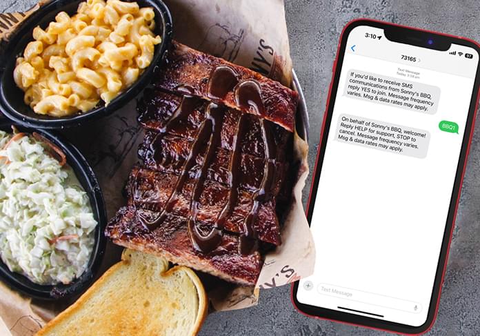 Text message with offer on phone next to plate of BBQ