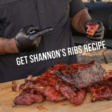 Man points to Baby Back Rib he's holding while multiple racks sit below him, text reads 