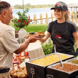 Sonny's catering server adds brisket to plate