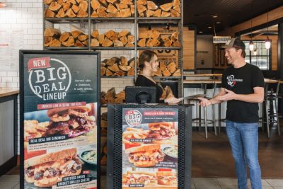 Two Sonny's employees chat together in entry way