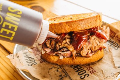Sonny's Sweet Sauce drizzled on Pulled Pork Sandwich