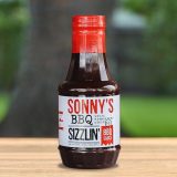 A bottle of Sonny's BBQ Sizzlin' BBQ sauce.