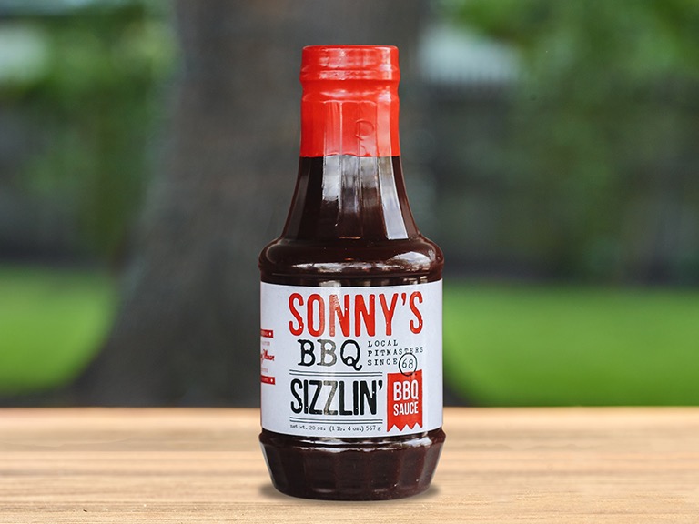 A bottle of Sonny's BBQ Sizzlin' BBQ sauce.