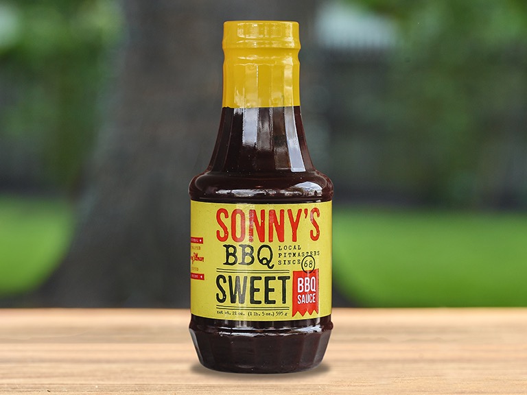 A bottle of Sonny's BBQ Sweet BBQ sauce.