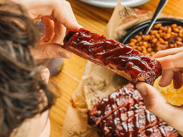 Sonny's BBQ Customer eats St. Louis Style Ribs