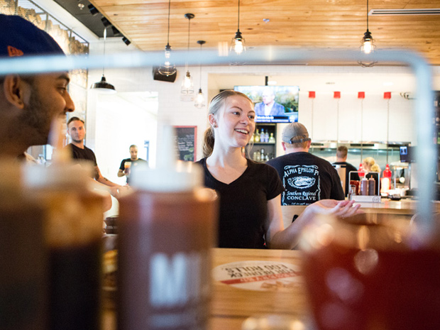 Sonny's BBQ Server laughs with guests