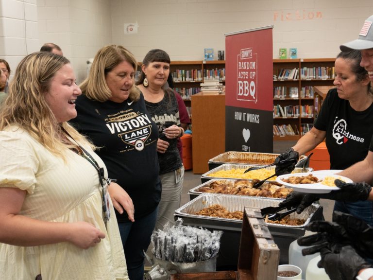 Teachers walk through Catering Line set up by Sonny's BBQ