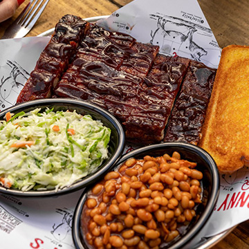 A Sonny's BBQ plate of St. Louis Ribs, garlic toast, coleslaw and BBQ Beans