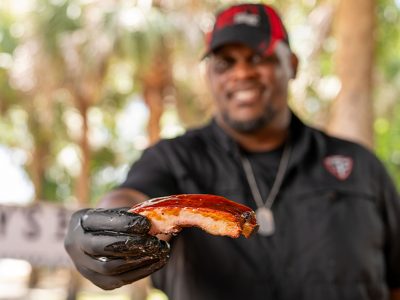 Head Pitmaster Shannon Snell hold St. Louis Rib towards camera