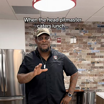 Man stands in kitchen with text above reading 