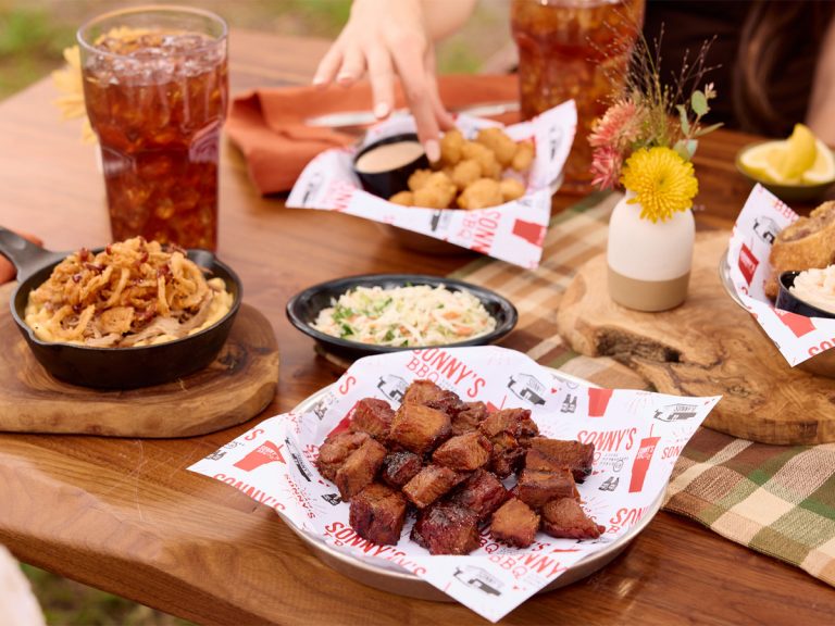 Sonny's BBQ Fall Menu Items sit on tablescape, including Maple BBQ Pork Burnt Ends, Mac & Cheese, Cheese Curds and more.