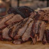 Sliced and chopped brisket sit on cutting board.