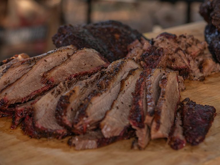 Sliced and chopped brisket sit on cutting board.