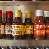 Closeup of Sonny's BBQ Sauces lined up in cabinet
