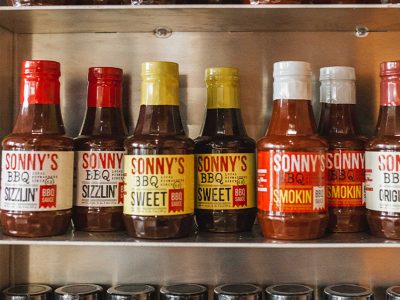 Closeup of Sonny's BBQ Sauces lined up in cabinet