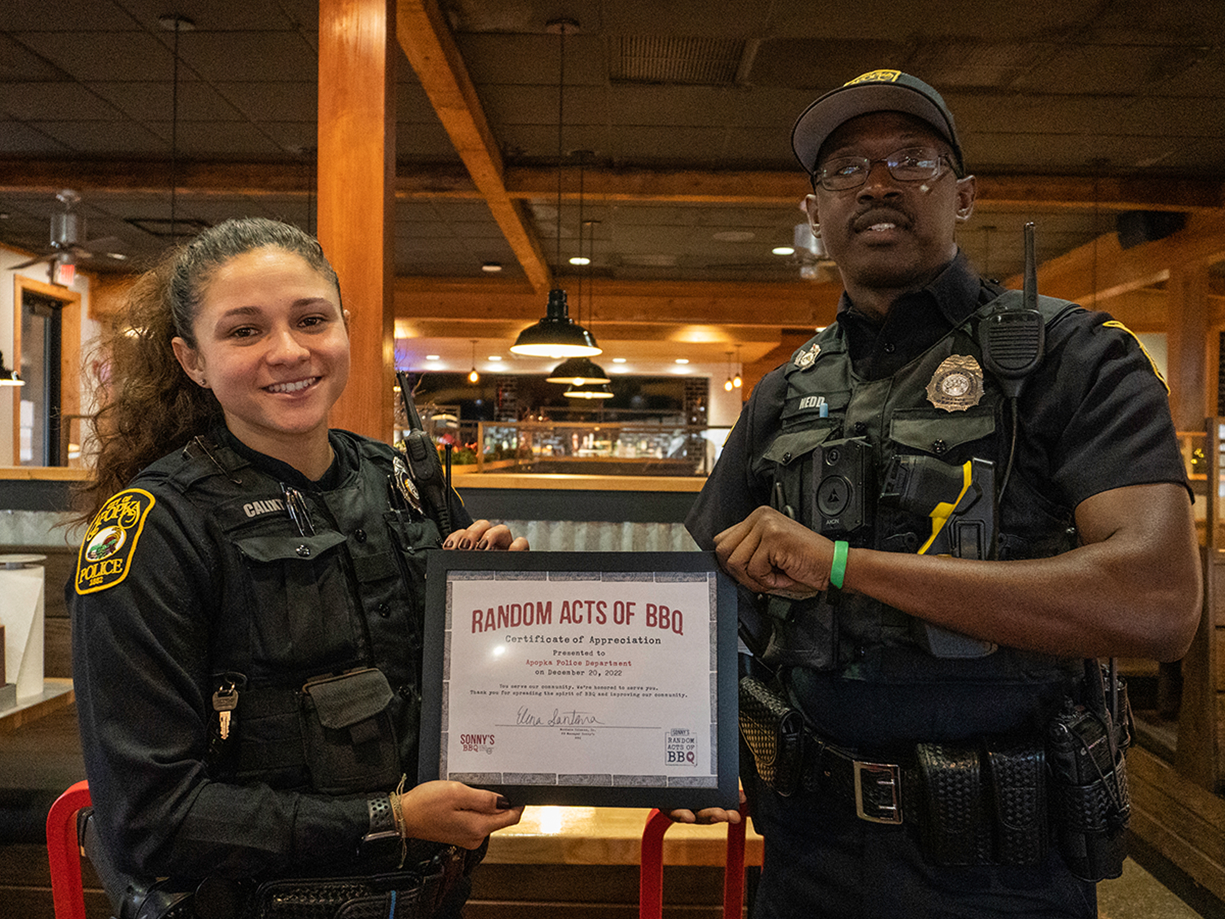 Two officers stand with certificate reading 