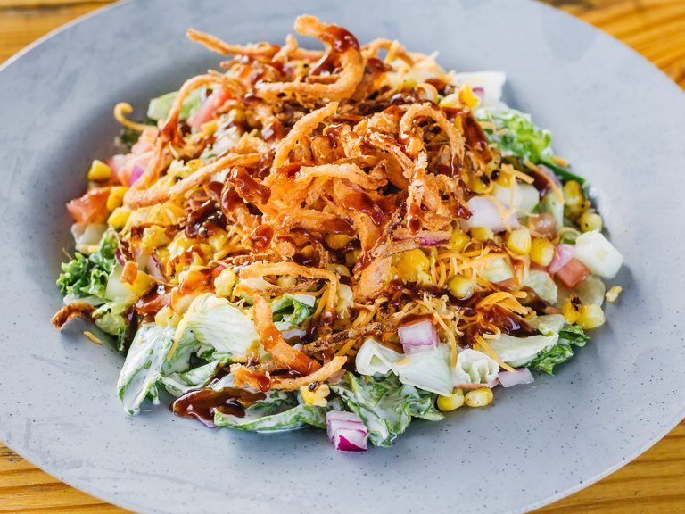 Blue bowl filled with Sonny's BBQ Salad, without meat.