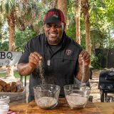 Pitmaster drops pinches of BBQ rubs into bowls