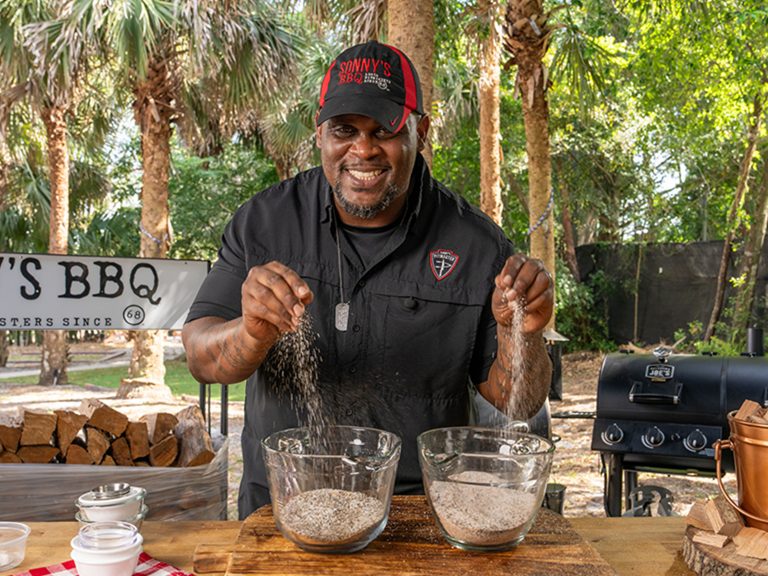 Pitmaster drops pinches of BBQ rubs into bowls