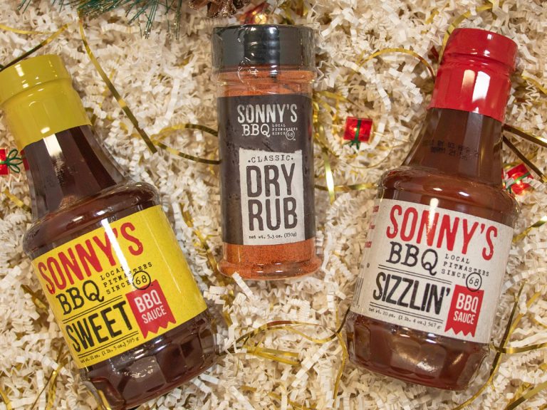 Bottles of Sweet and Sizzlin BBQ Sauce sit next to bottle of Dry Rub