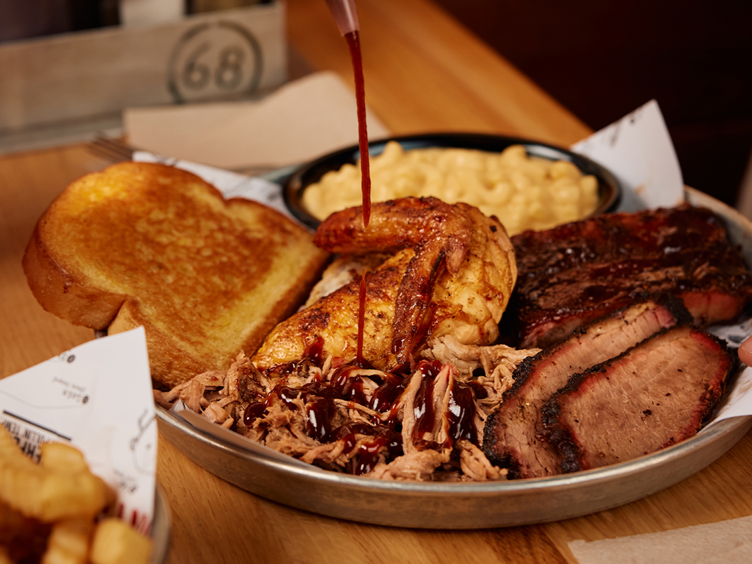 BBQ Sauce being squeezed onto Sonny's Sampler.