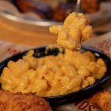 Fork scoops Mac and cheese out of bowl on Sonny's table.