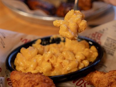 Fork scoops Mac and cheese out of bowl on Sonny's table.