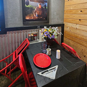 Empty table with place setting below 