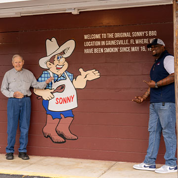 Sonny Tillman and Shannon Snell stand outside original Sonny's in Gainesville.