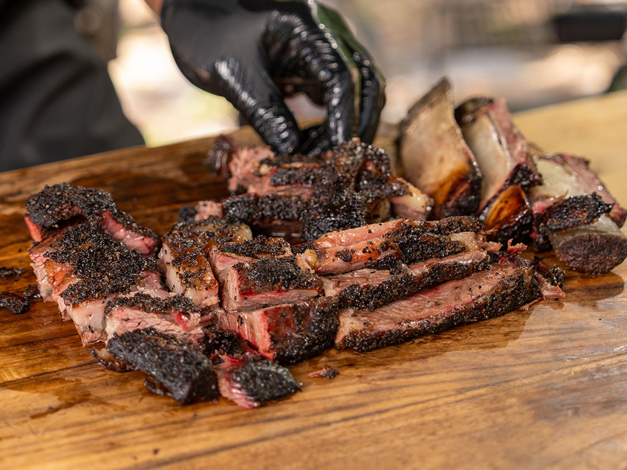 Sliced smoked beef ribs on Tales from the Pit cutting board.