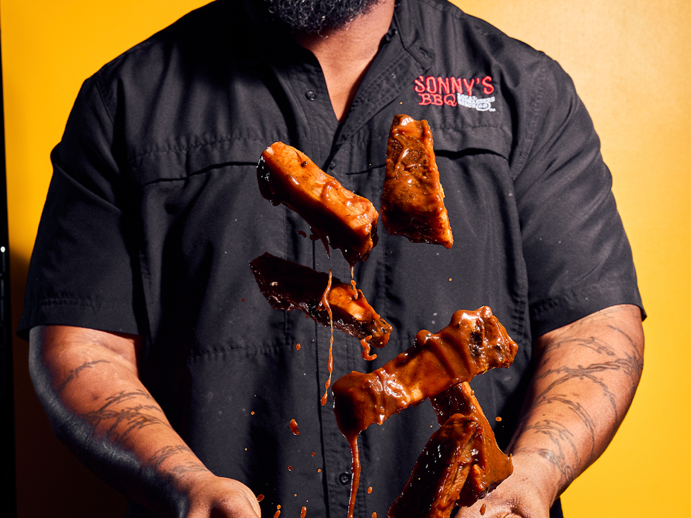 Pitmaster Tossing Ribs into Air