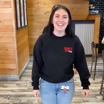 Team Members stand in line in restaurant.