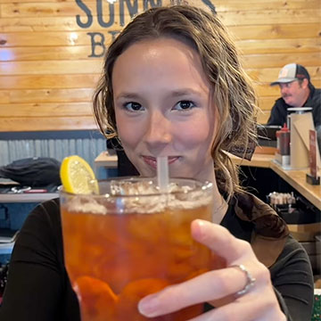 Team Member holds up Raspberry Tea
