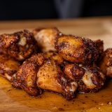 Bourbon Smoked and Fried Chicken Wings layed out on cutting board.
