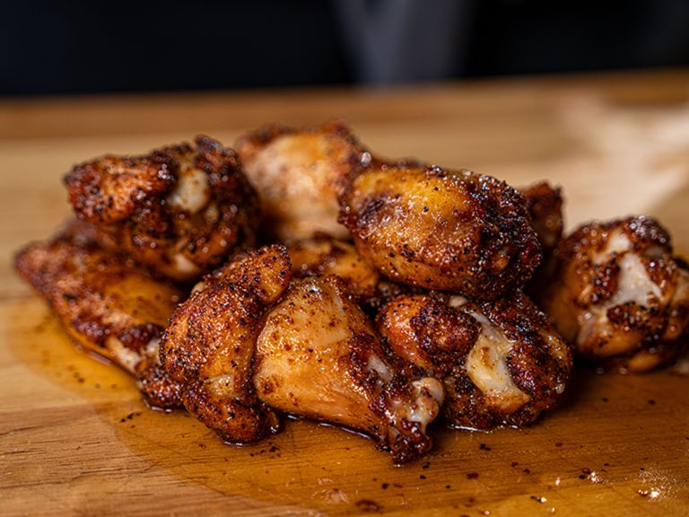 Bourbon Smoked and Fried Chicken Wings layed out on cutting board.