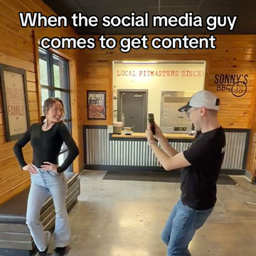 Team Member poses as other team member films.