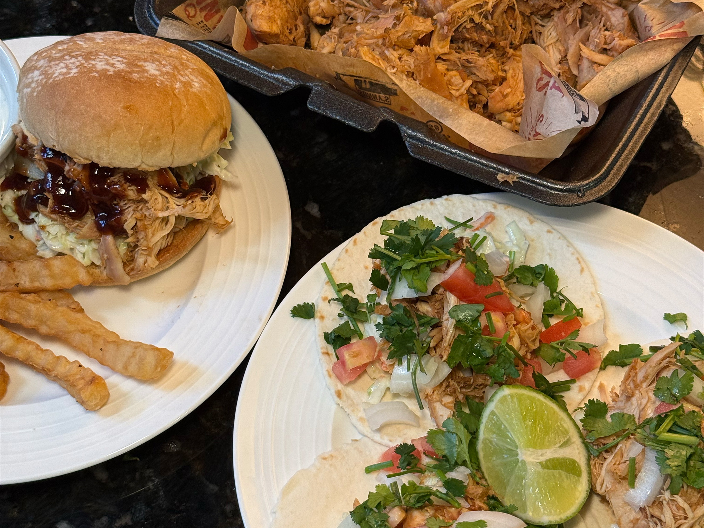 Two Pulled Chicken Recipes on table along with pound of Sonny's Pulled Chicken