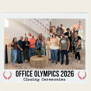 Group smiles at camera with text reading 