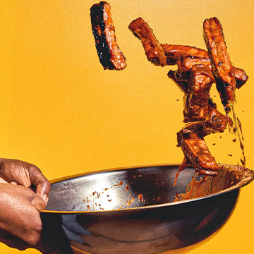 Ribs being tossed in bowl