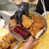 Server places cornbread in middle of packed plate at backyard catering