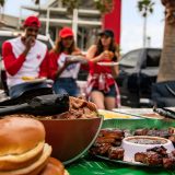 Sonny's BBQ catering spread on a tailgate table before a football game