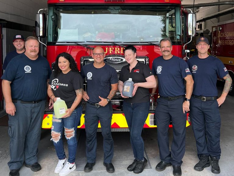 Sonny's team poses with Firefighters  in front of fire truck!